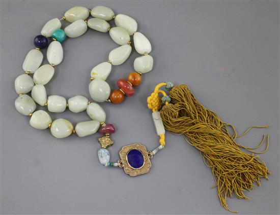 A Chinese pale celadon jade pebble and hardstone necklace, probably Republic period, total drop incl. silk tassle pendant 72.5cm